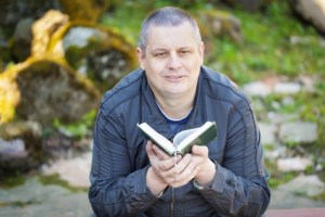Religious man with Holy Bible at Place of Worship